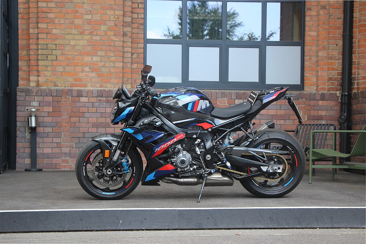 A superbike heavily leaned over on track with electronic rider aids visibly engaged