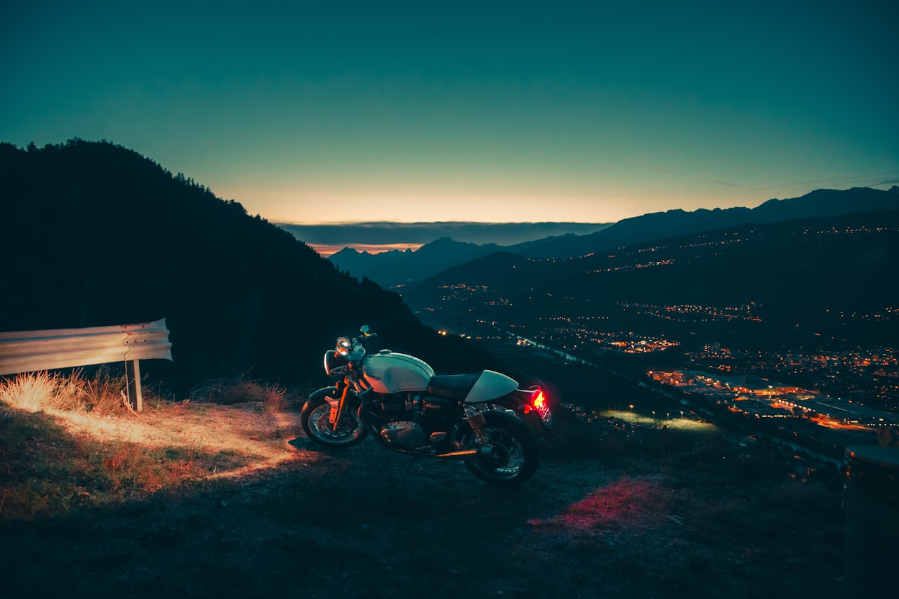 A learner rider inspecting a used naked motorcycle parked on a city street